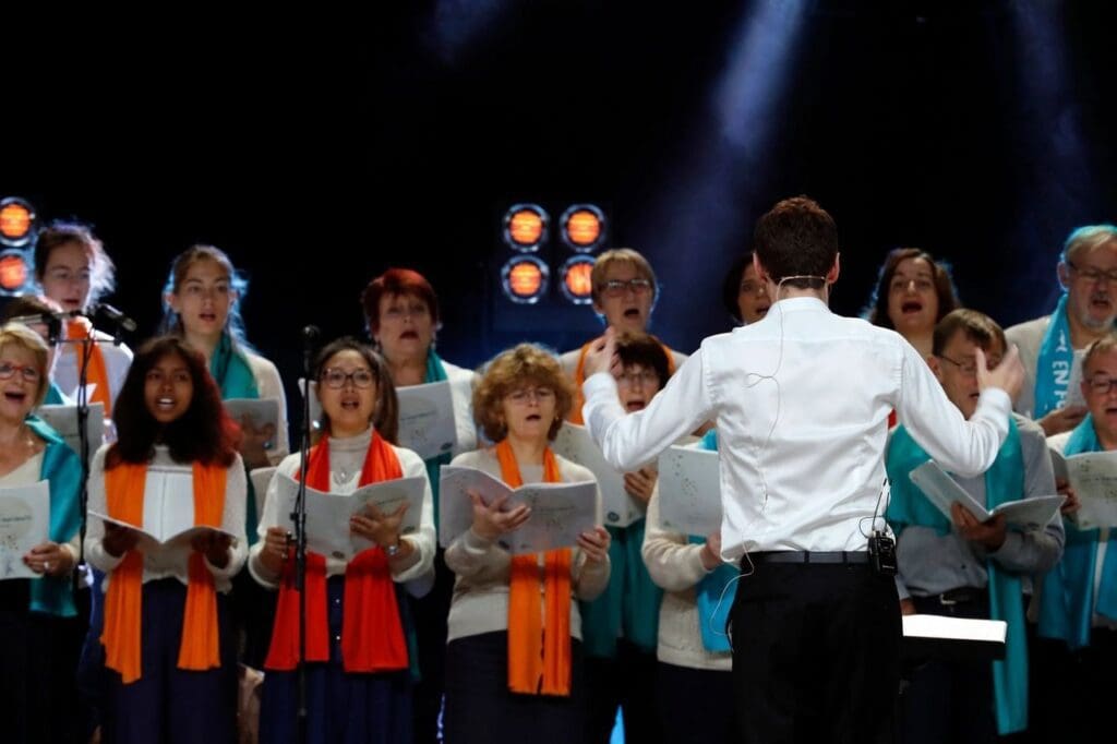 A group of people singing in front of a microphone.